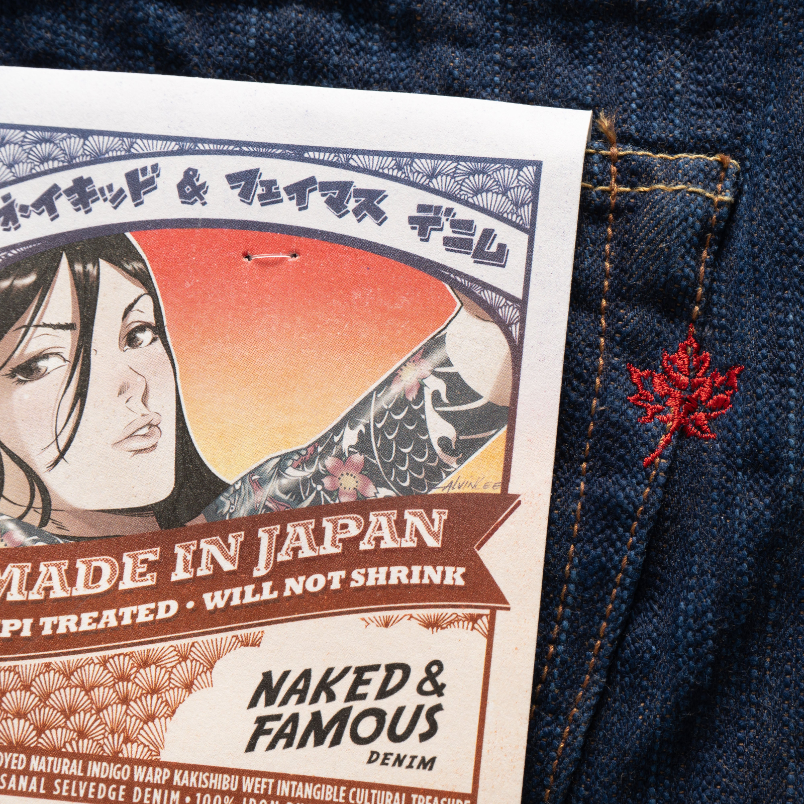 Naked & Famous denim MIJ label on a blue denim fabric with a red embroidered maple leave.